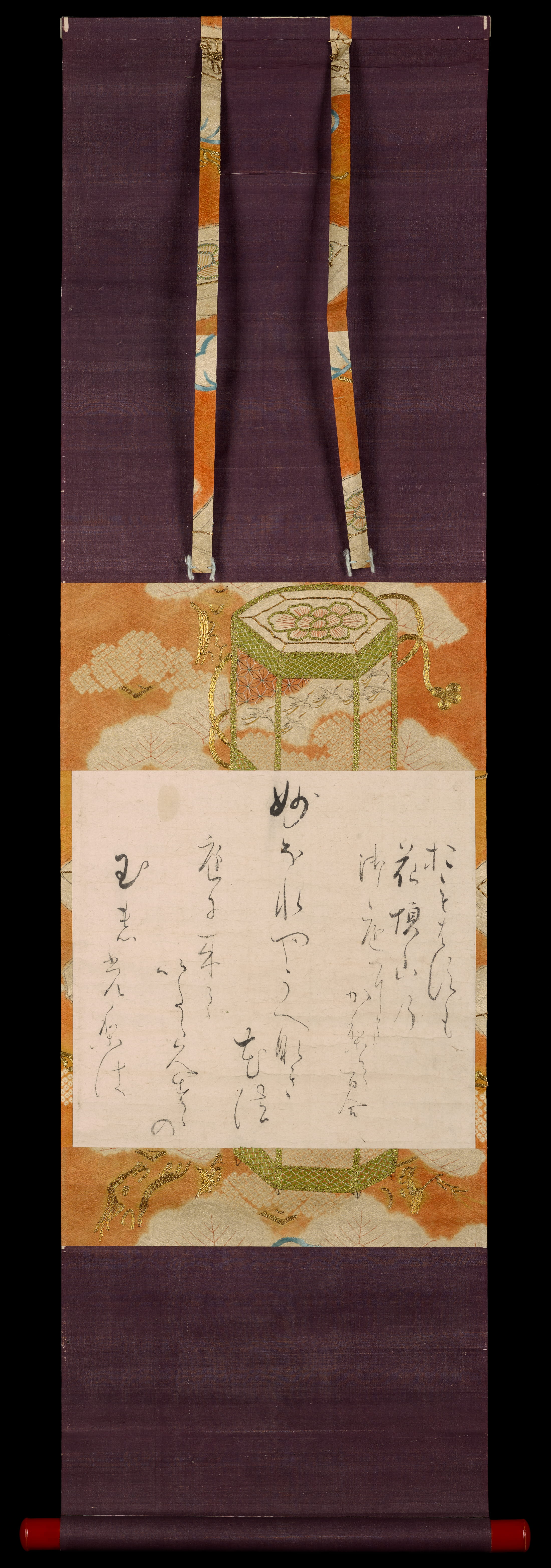 A square sheet of paper inscribed with flowing calligraphy, mounted on a vertical orange cloth with cream-colored clouds and green and gold embroidery.